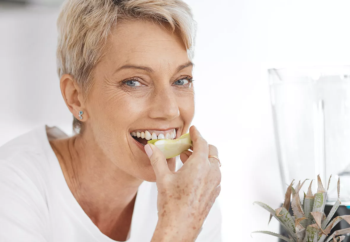 Woman biting fruit